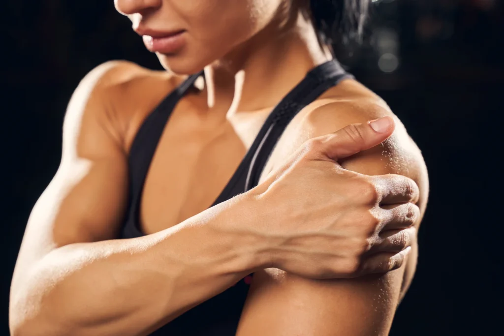 strong woman holding her shoulder in gym 2026 03 24 00 37 49 utc